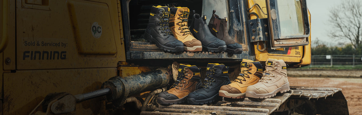A collection of Caterpillar Striver XL Boots on a Caterpillar industrial powerplant vehicle