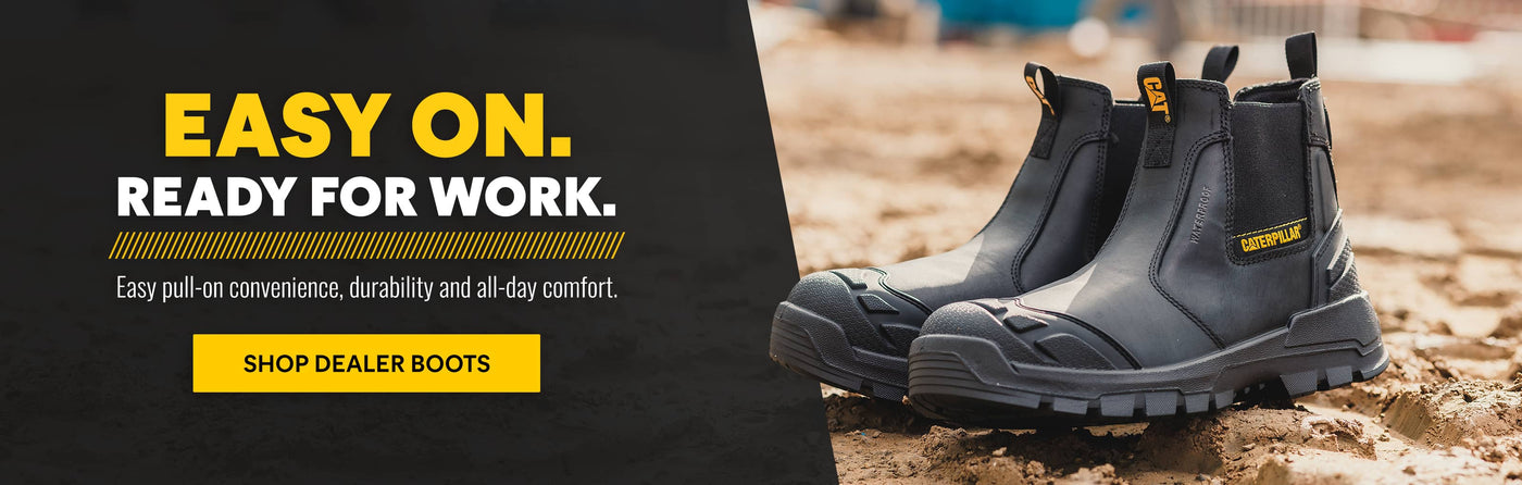 Black Caterpillar dealer boots positioned on sandy ground, with a blurred background and text highlighting their convenience and durability. Click to shop.