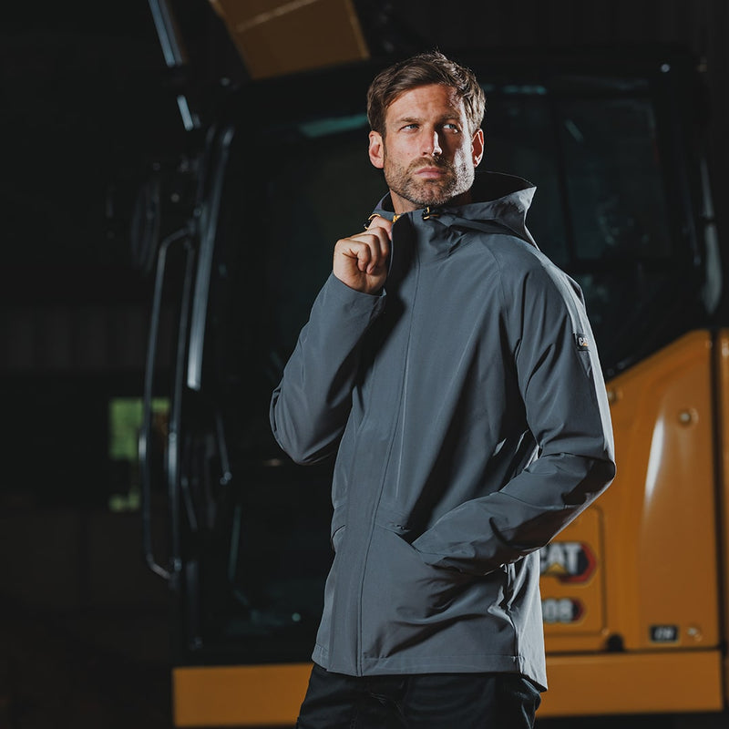 Man wearing a Caterpillar Dark Shadow Essentials Rain Jacket