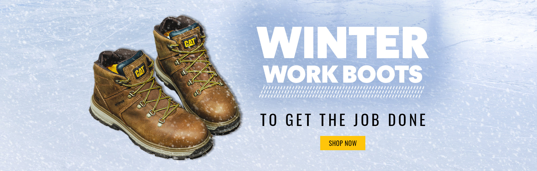 A pair of brown Caterpillar Exposition Safety Boots on an icy surface with snow falling